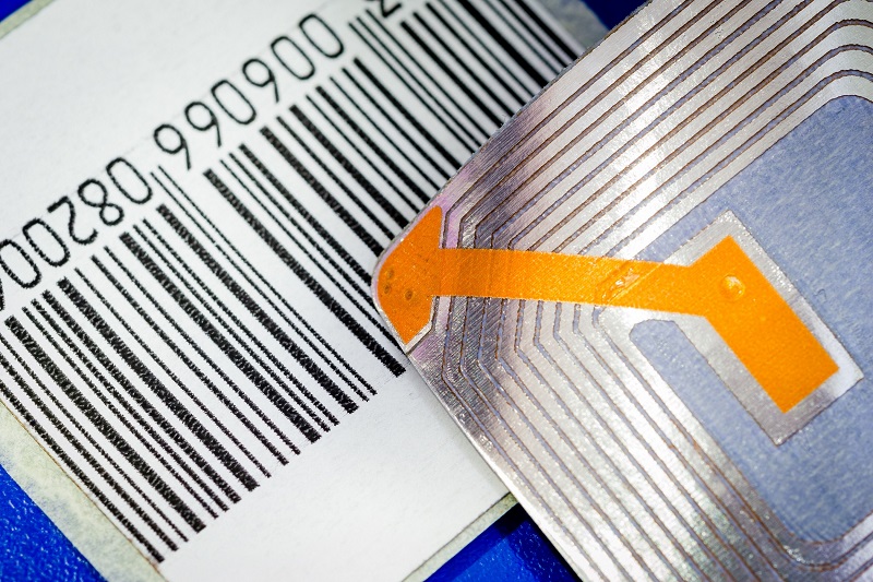 Close up of RFID tags and a code bar used for tracking and identification purposes and as an anti-theft system in commerce and retail.