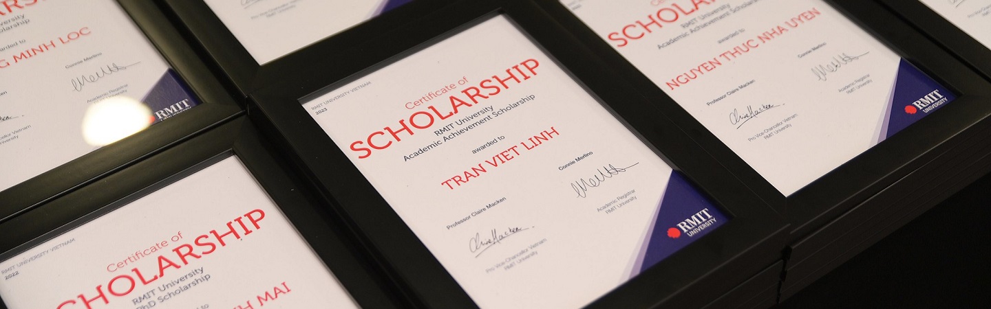 framed scholarship certificates displayed on a table