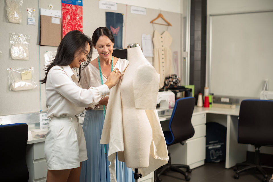 Student with lecturer in fashion lab