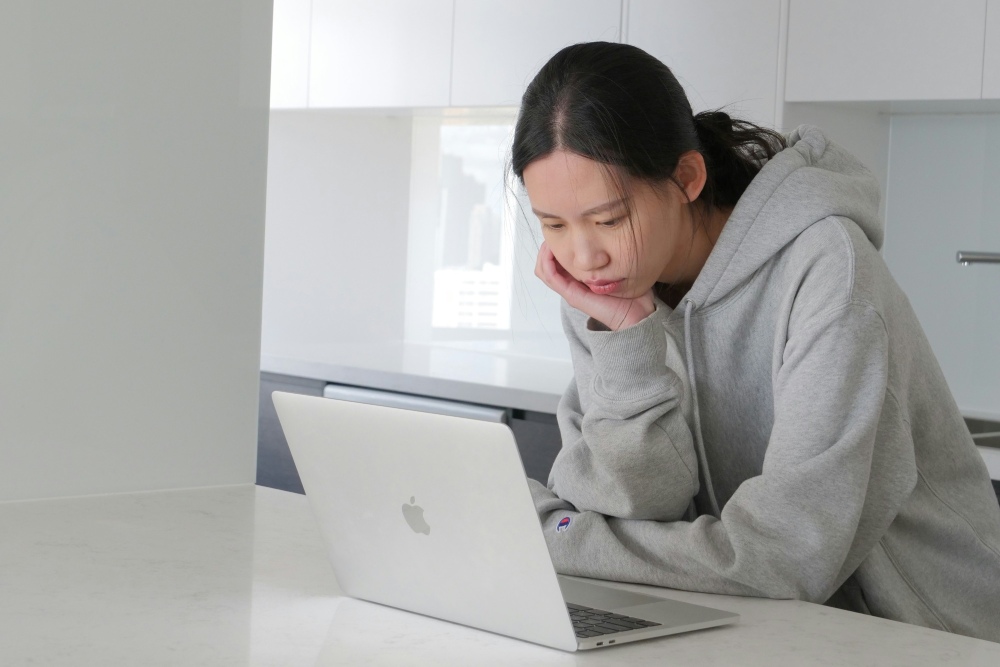 Teenager staring at a laptop