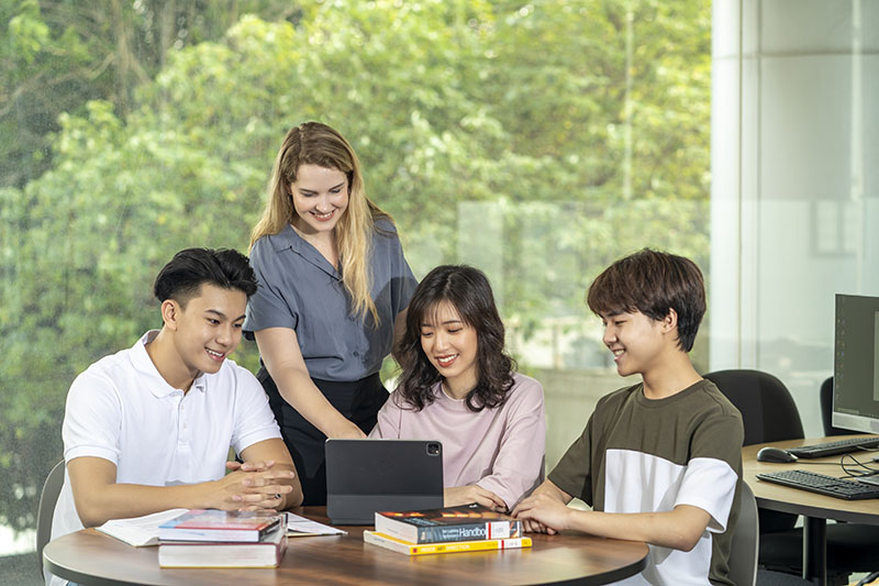 thumbnail-three-students-and-a-teacher-around-classroom-table.jpg