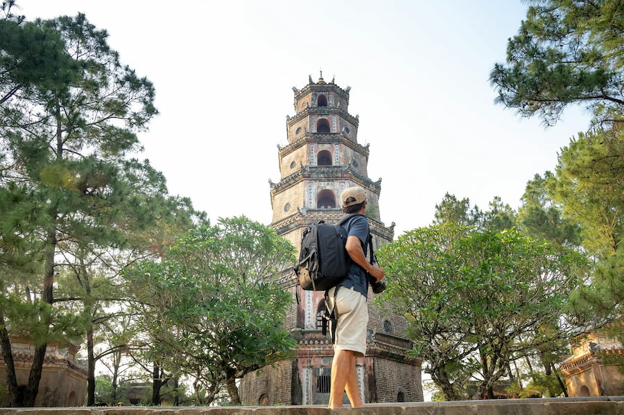 Tourist looking at a pagoda in Hue