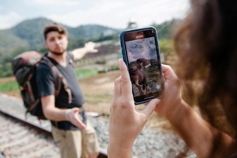 Tourists filming travel video