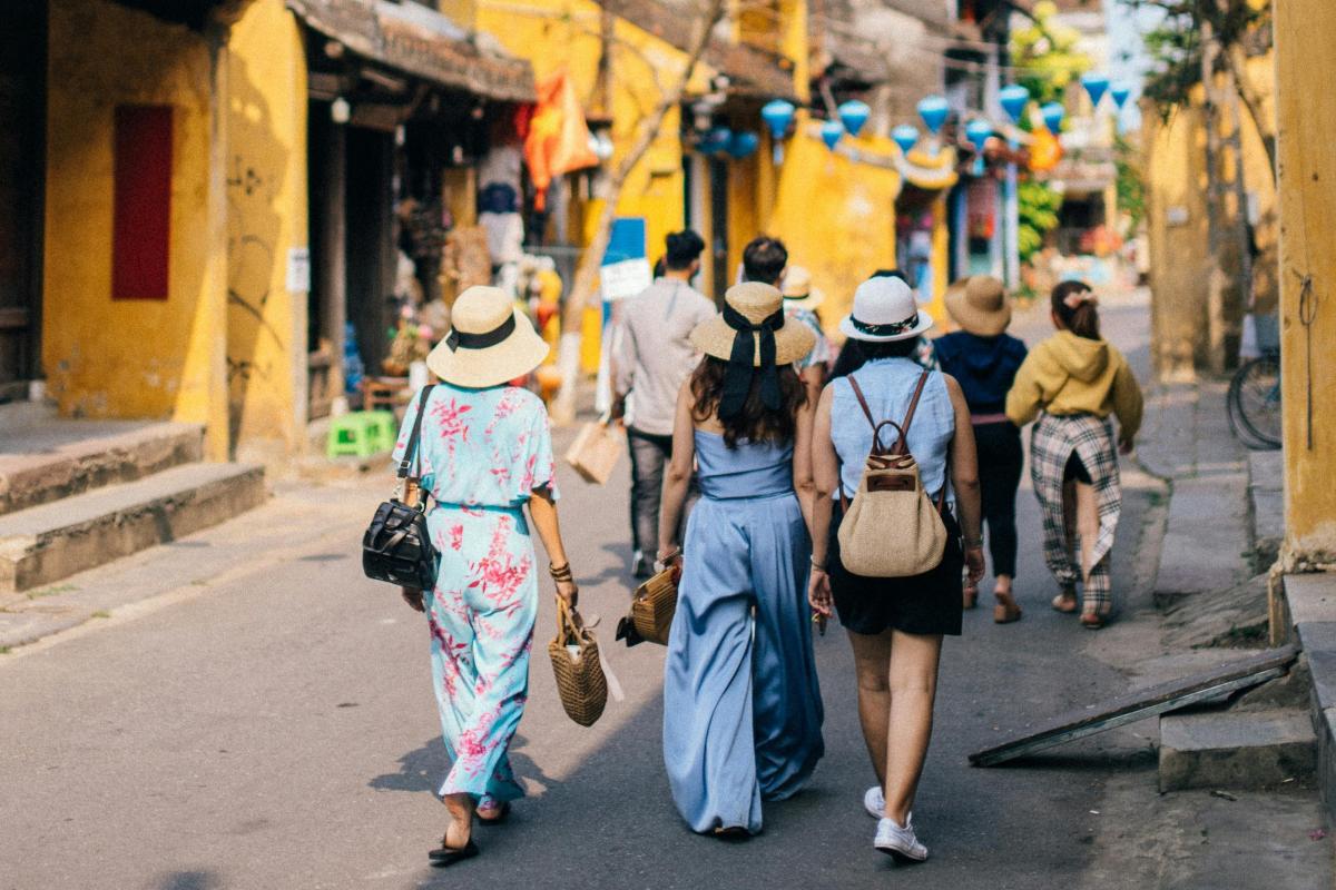 Groups of tourists walking in Hoi An ancient town