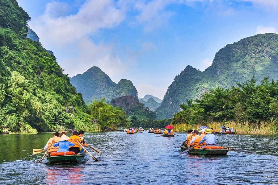 Tourists on boats in Trang An, Vietnam