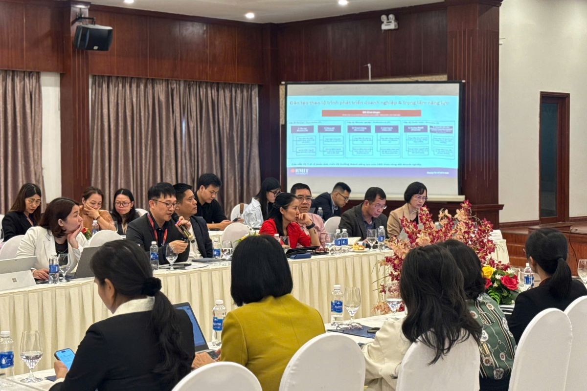 People sitting at tables listening to a presentation