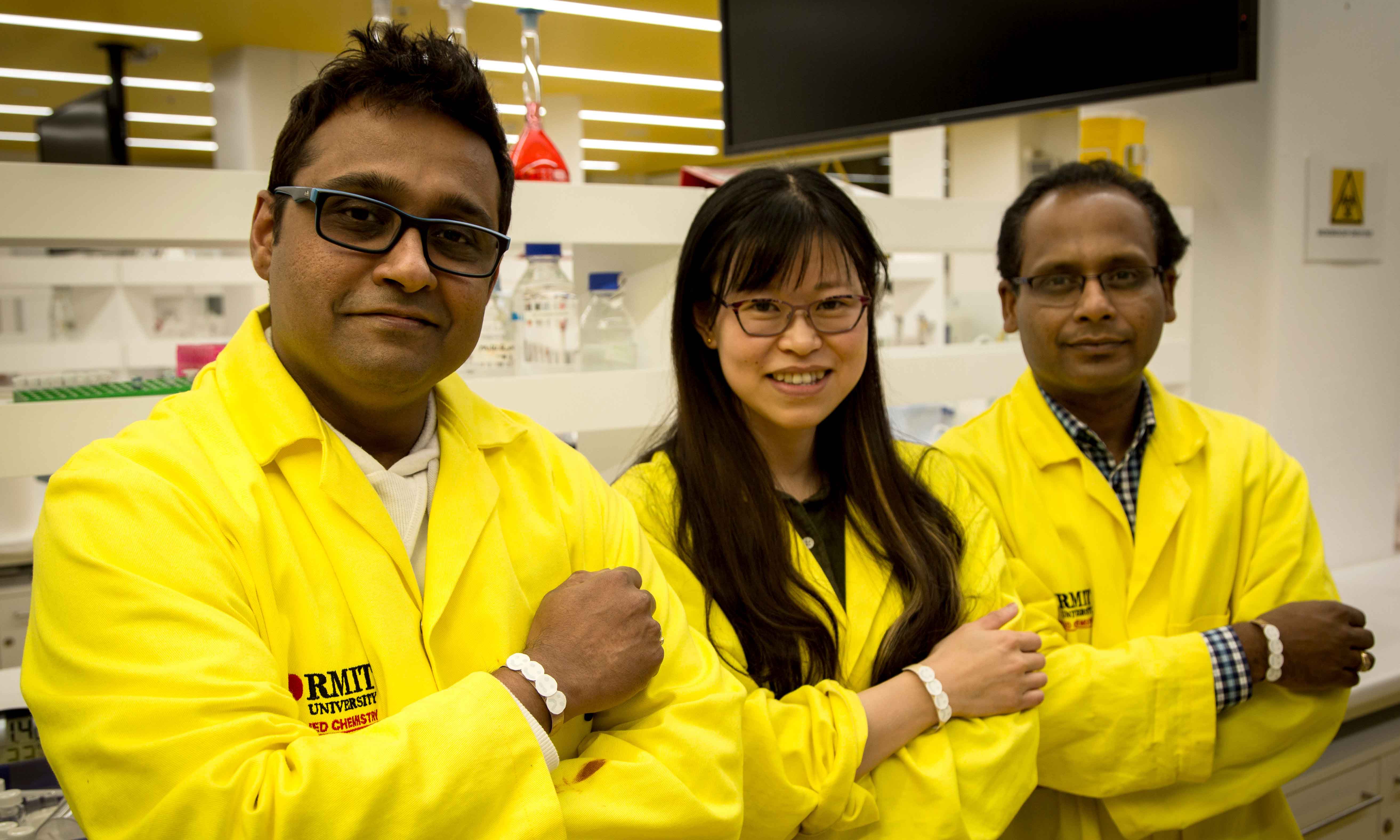 RMIT researchers from the Ian Potter NanoBioSensing Facility wearing prototypes of their UV sensor, from left to right, Dr Rajesh Ramanthan, PhD candidate Wenyue Zou and Professor Vipul Bansal.