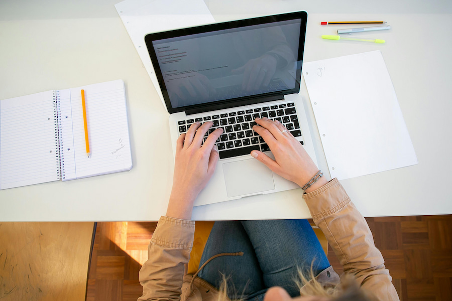 View from above of person typing on laptop