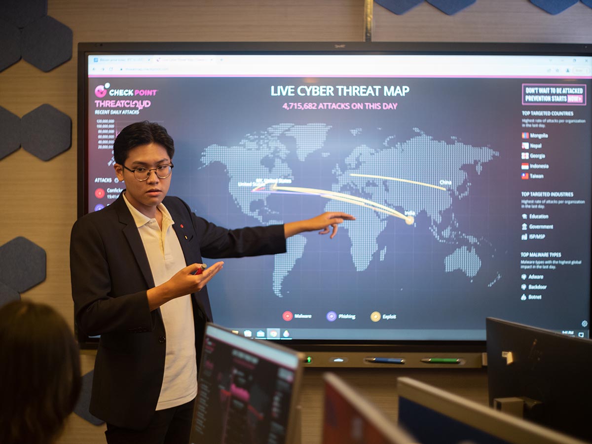 Male student presenting a map on tv screen