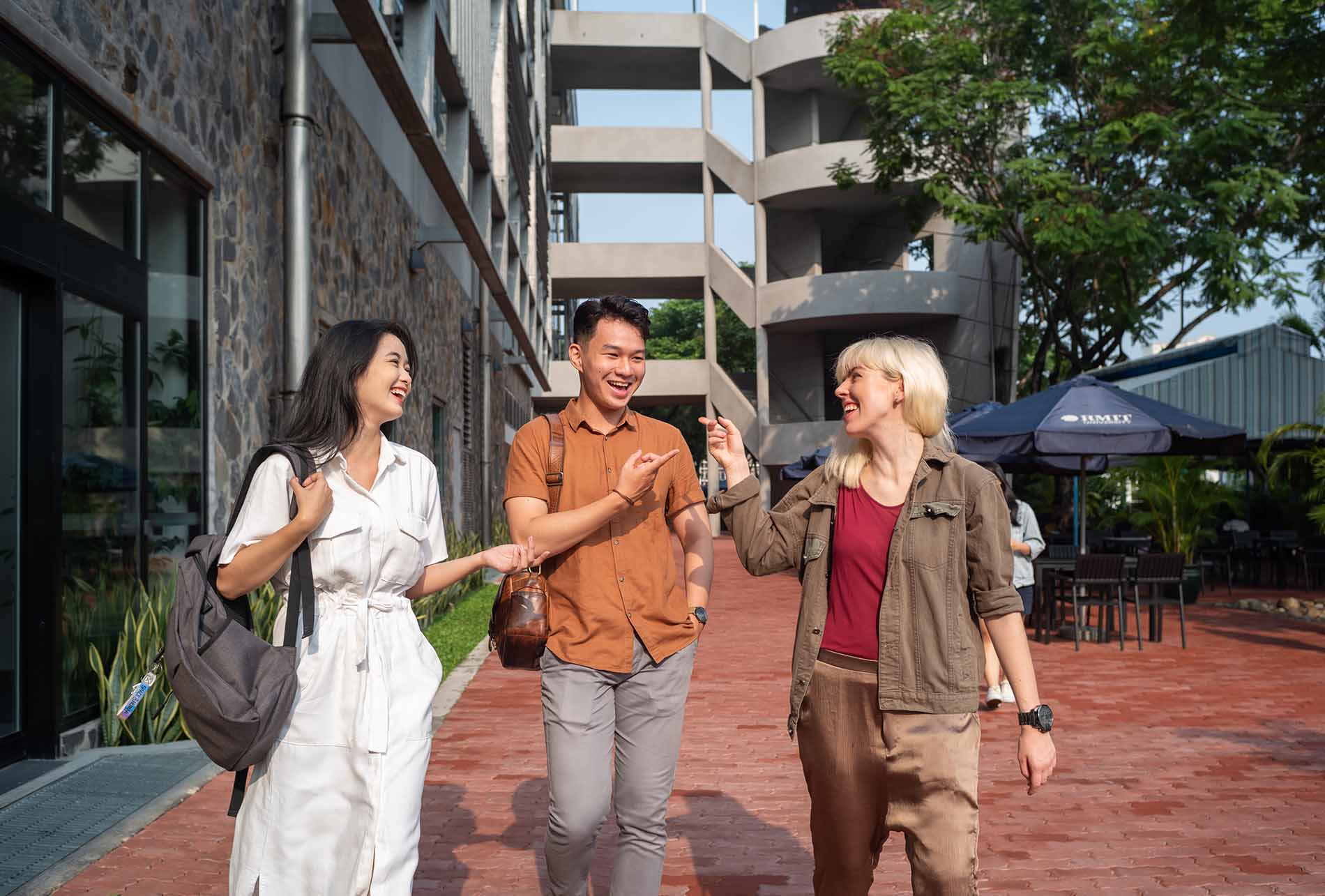 three-university-students-walking-and-chatting.jpg