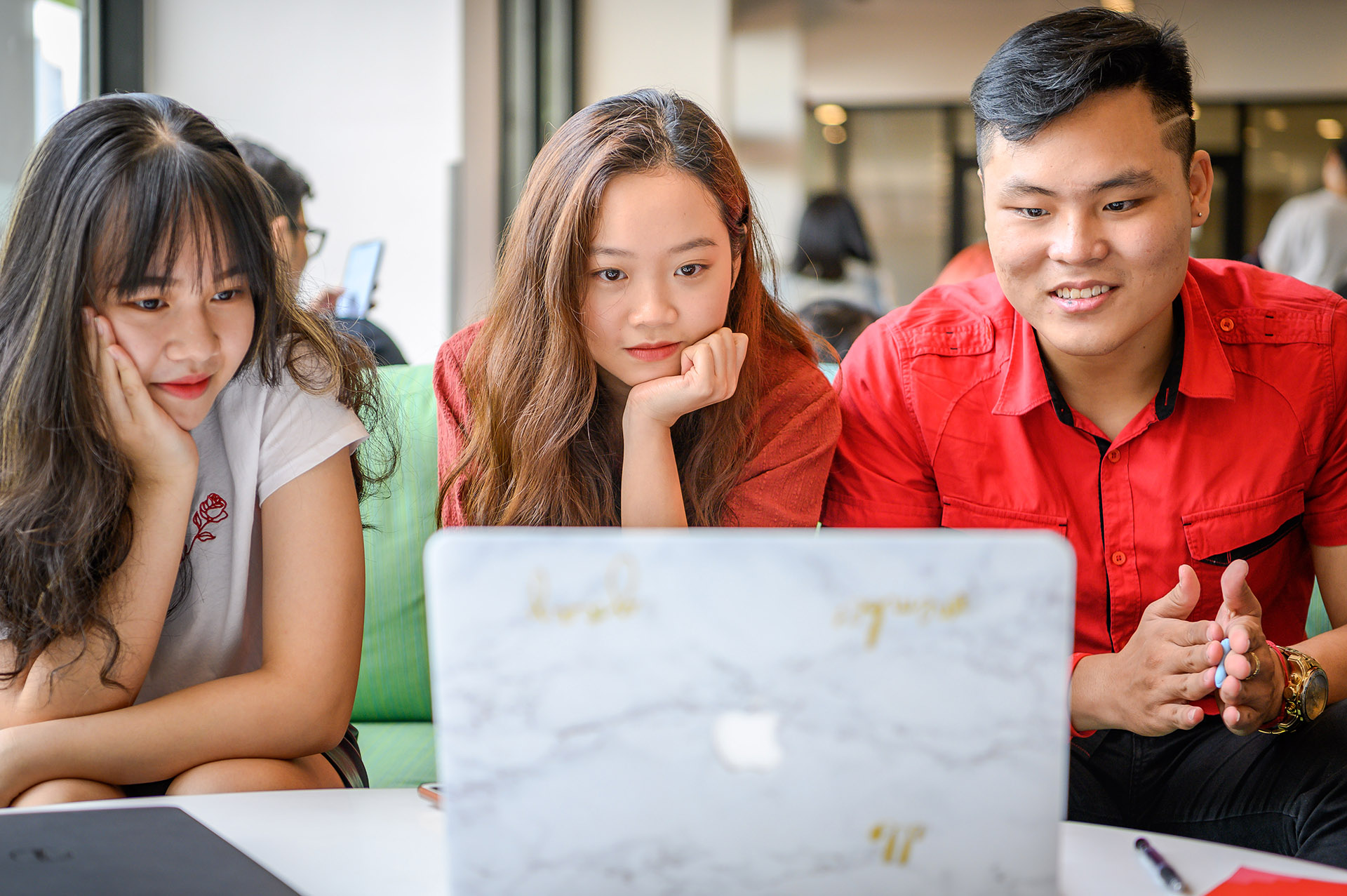 Students browsing a website on a laptop.