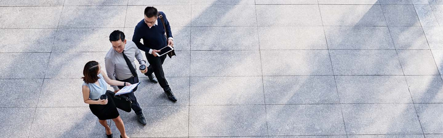 three business people walking together