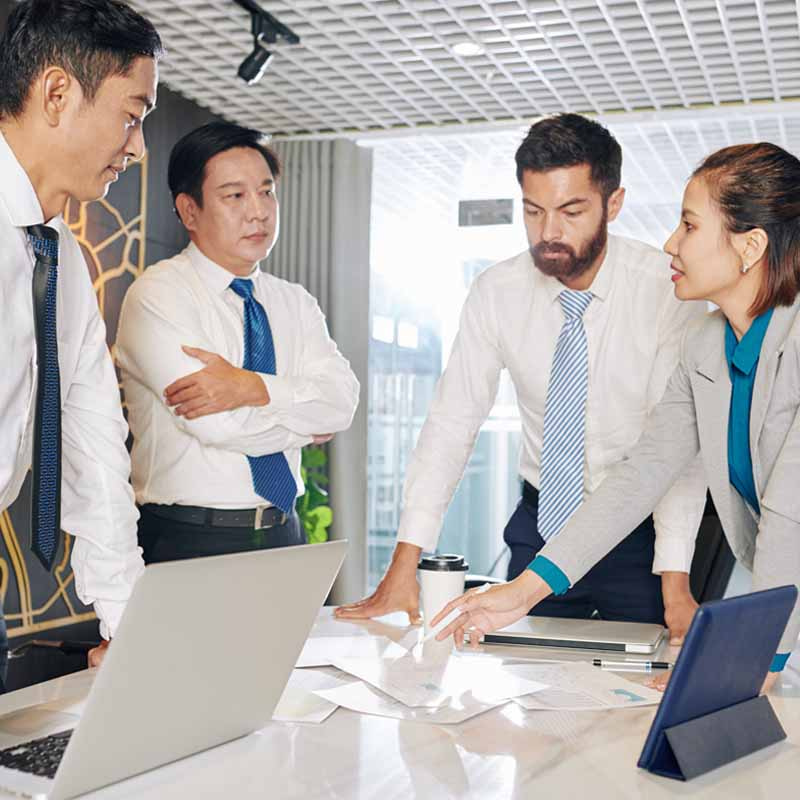 a group of 4 business people discussing work