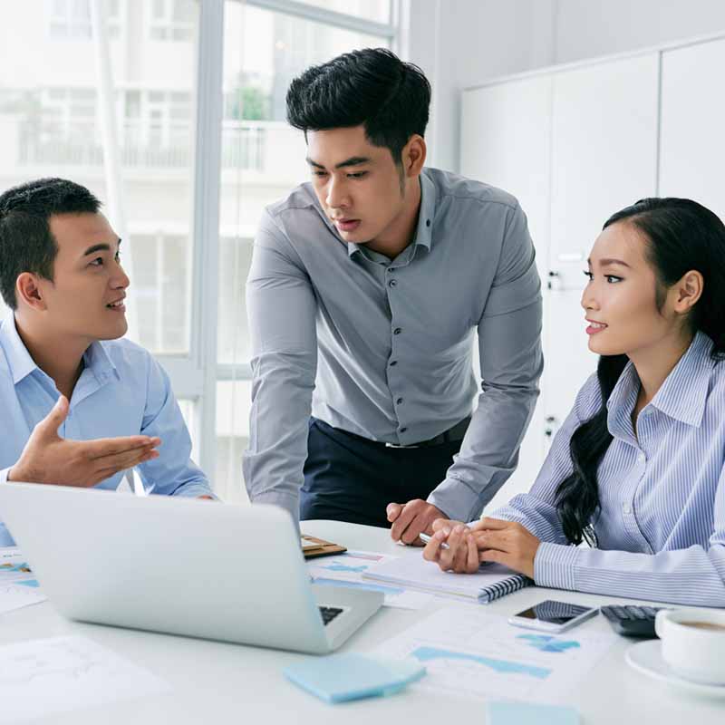 a group of 3 business people discussing work