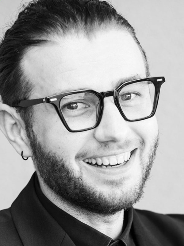 a headshot of a man smiling 