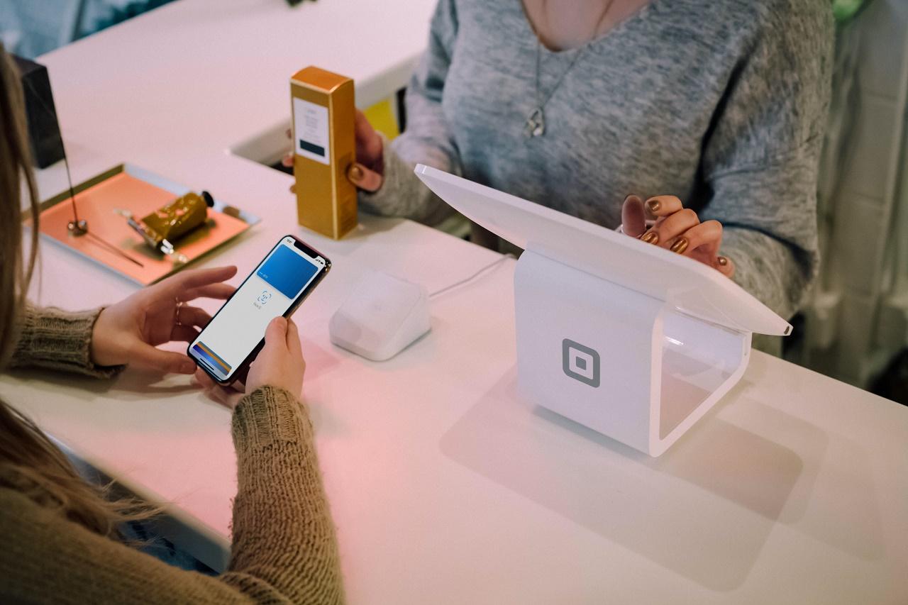 2 ladies processing payment using Square, a fintech solution. 