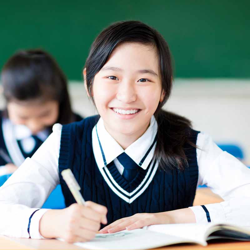 a highschool student smiling at the camera