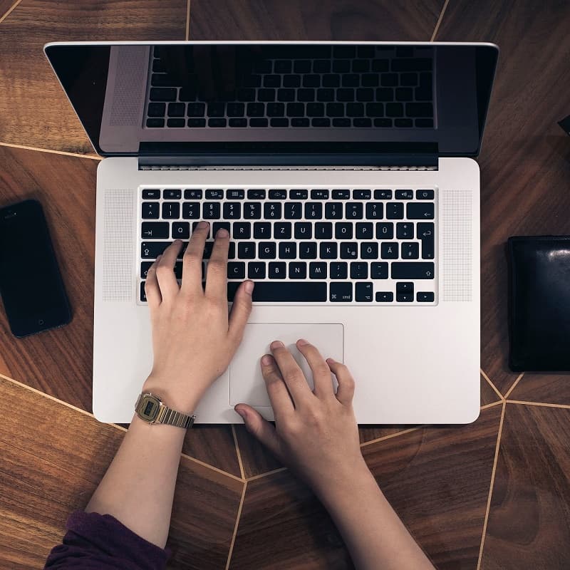 hands-overhead-laptop-wood-square.jpg