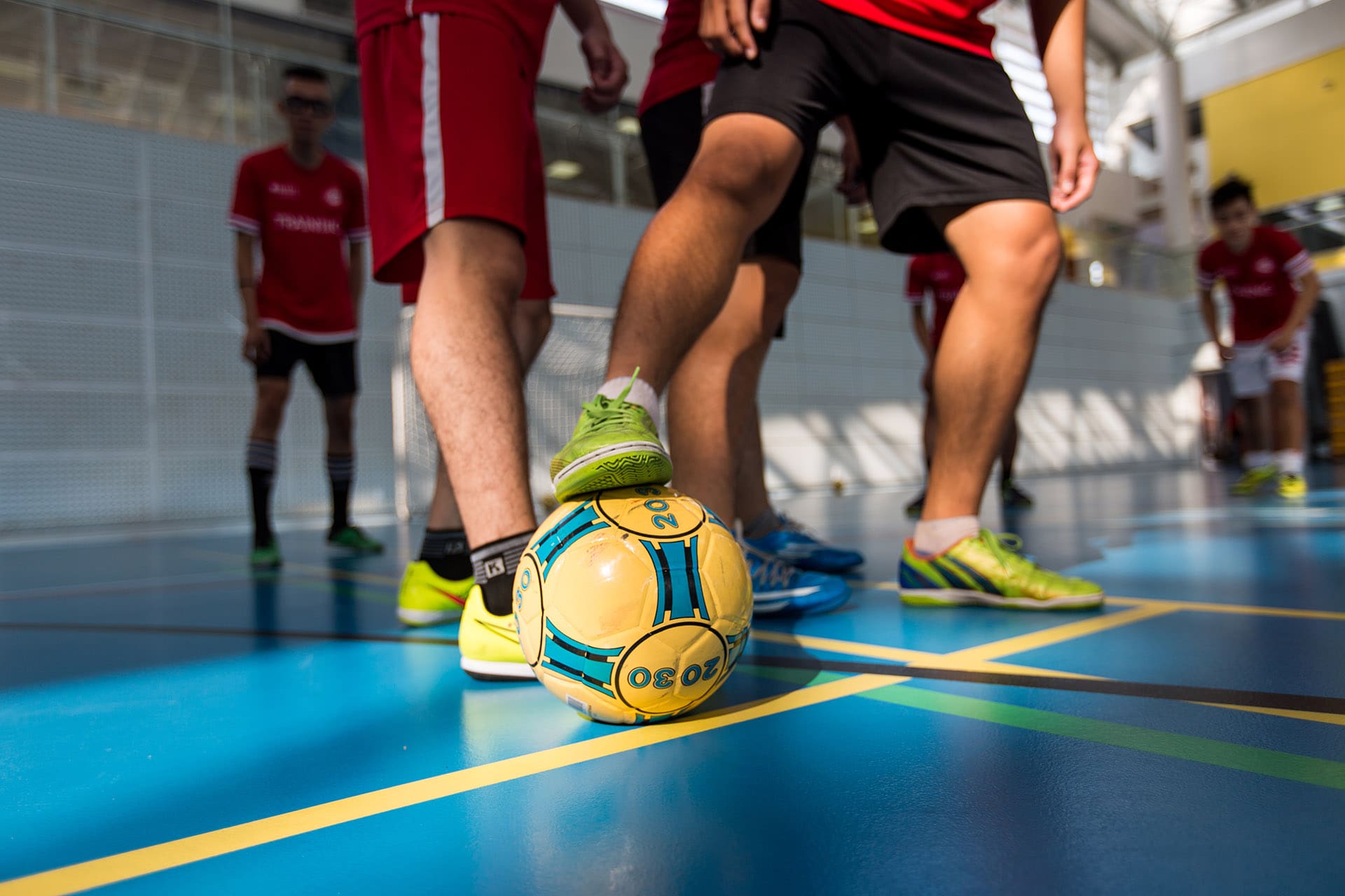 People kicking a football.