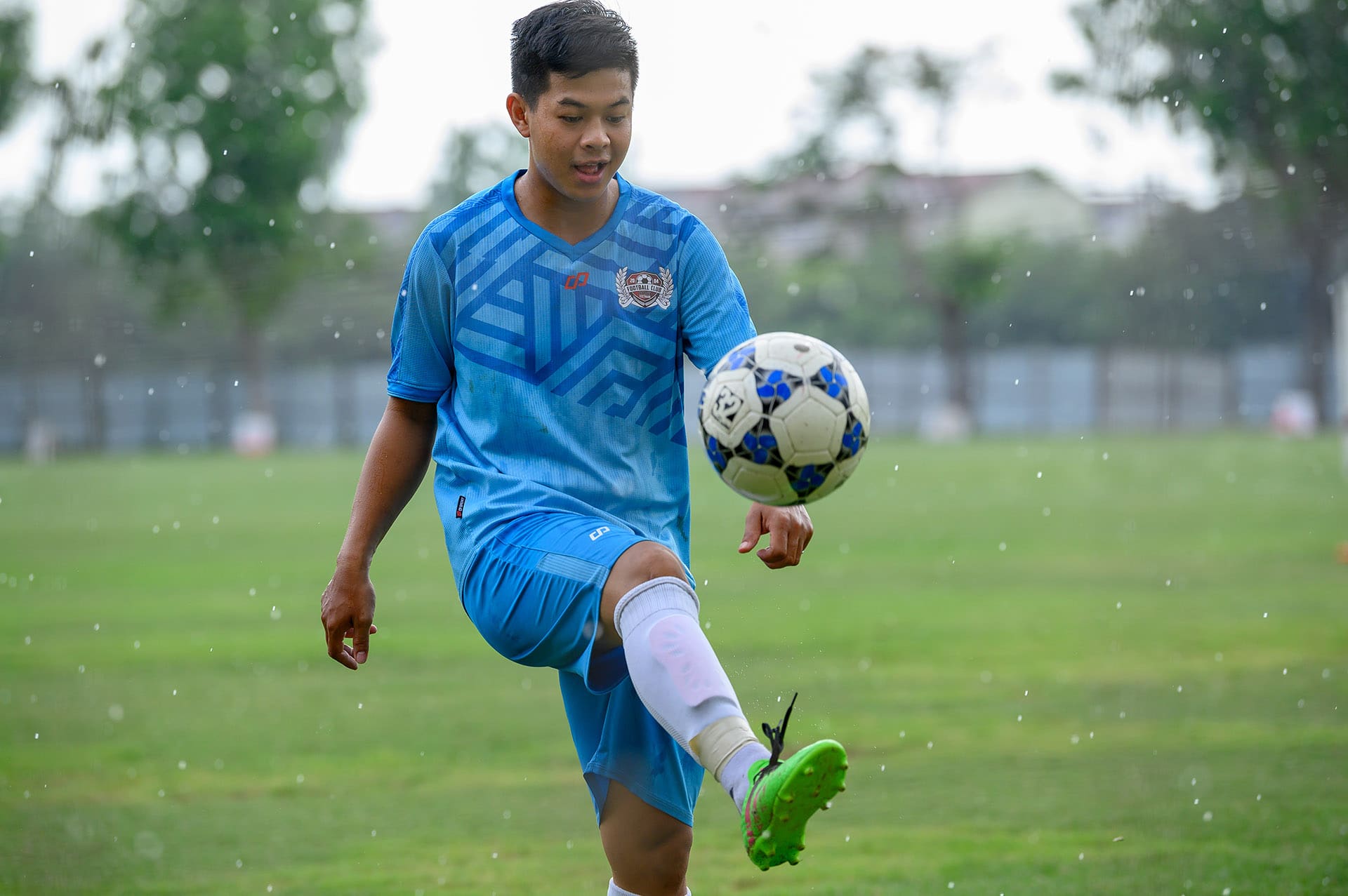 SGS Football club member kicking a ball.